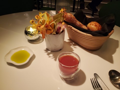 Bread, Olive oil, and complementary drink at Le Jardinier in Miami's Design District