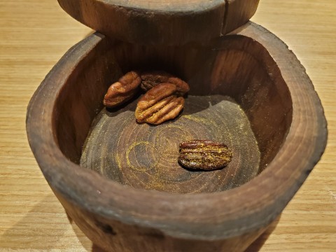 Curry flavored pecans hidden in a wooden container